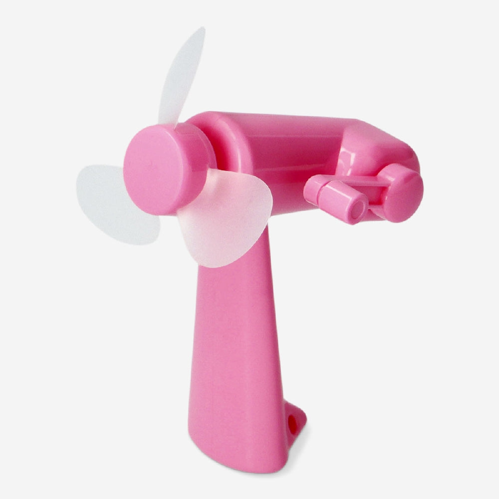 Pink handheld fan gadget by Flying Tiger Copenhagen, compact design with a colorful, portable fan for personal cooling.
