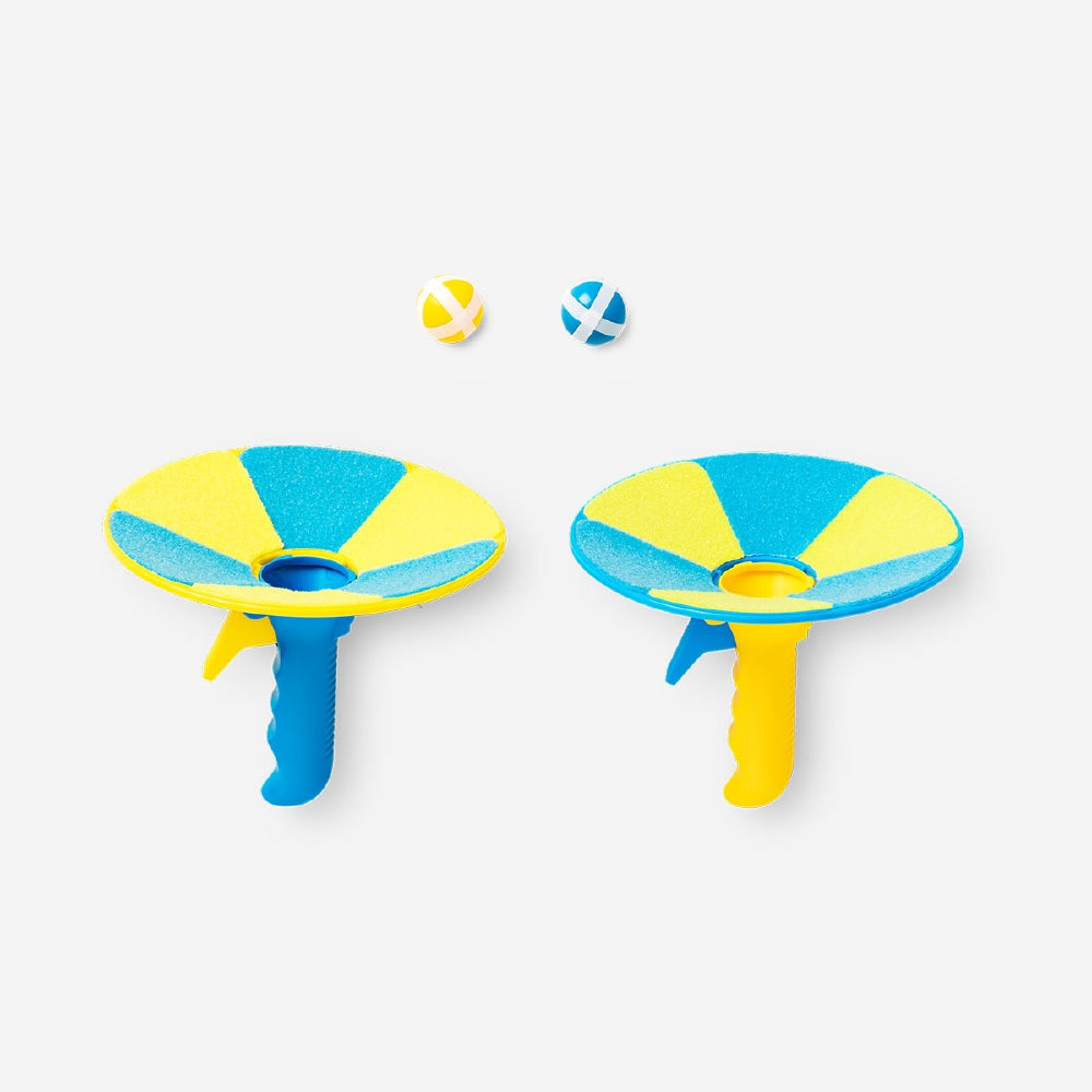 Flying Tiger Copenhagen shoot and catch game with colorful plastic paddles and ball for outdoor fun and active play.