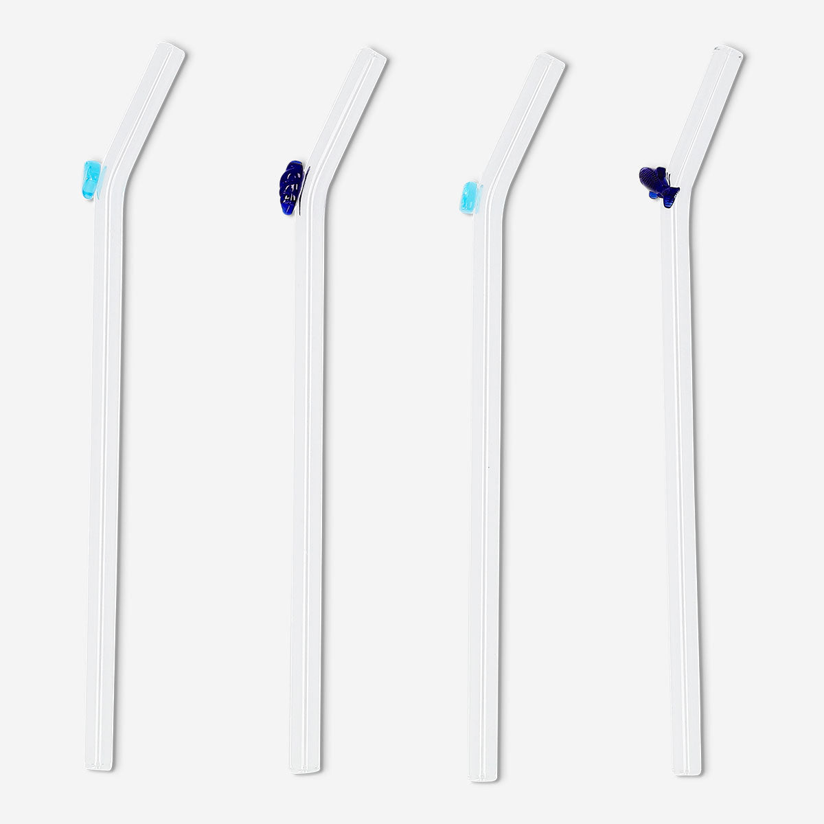 Set of four glass drinking straws with colorful fish and seashell decorations, perfect for summer beverages.