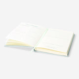 Flying Tiger Copenhagen Bedtime Journal in English, featuring a sleek office design with pages open for nighttime reflection.