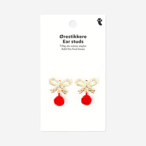 Red bell textile stud earrings with gold bow detail, stylish and playful jewelry by Flying Tiger Copenhagen