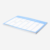 Blue A4 weekly planner from Flying Tiger Copenhagen, featuring pages for organizing weekly schedules in an office setting.
