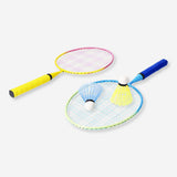 Gradient badminton set for game, featuring rackets and shuttlecocks, by Flying Tiger Copenhagen, arranged on a wooden surface.