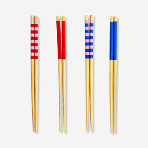 Set of four colorful wooden chopsticks from Flying Tiger Copenhagen for kitchen use, featuring vibrant, handcrafted design.