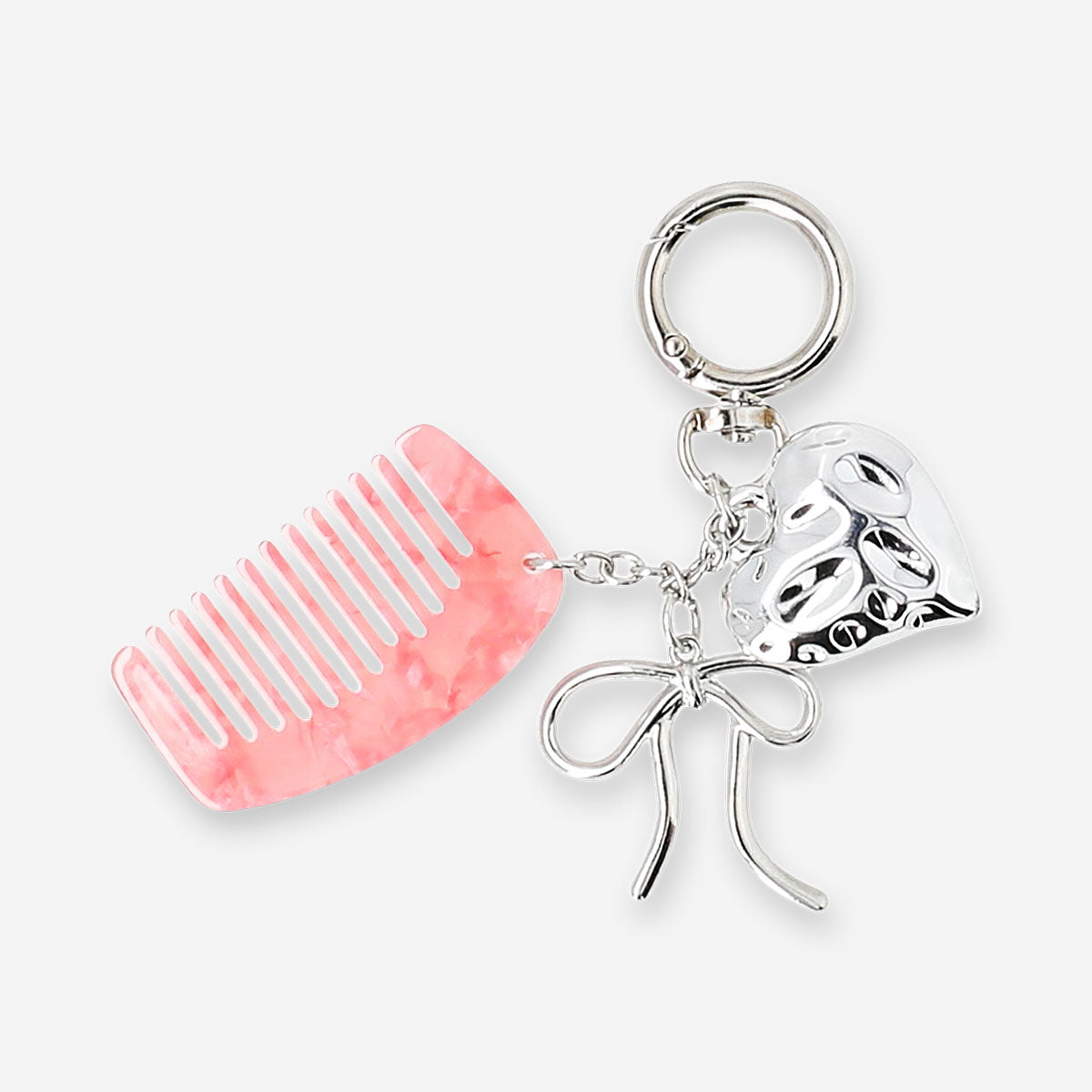 Colorful textile keyring with a hair comb and decorative charms, featuring vibrant patterns and playful design.