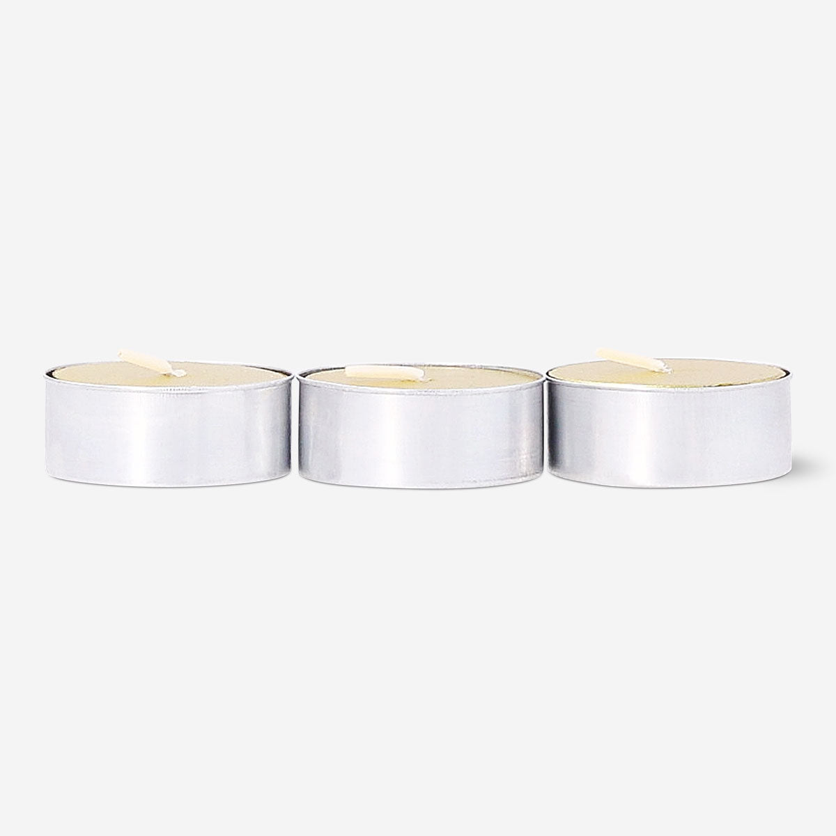 Set of four gold tealight candles for home decoration from Flying Tiger Copenhagen, arranged in a cluster on a neutral surface.