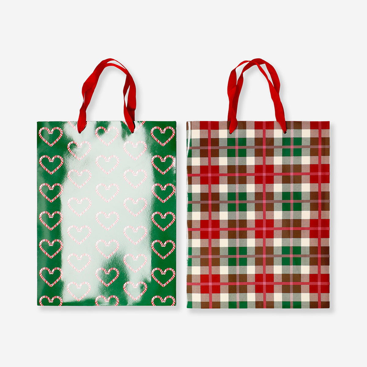 Two festive Christmas print gift bags from Flying Tiger Copenhagen, coated for durability, ideal for office gift wrapping.