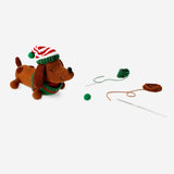 DIY crochet Christmas sausage dog hobby kit by Flying Tiger Copenhagen, featuring colorful crochet materials and a festive design.