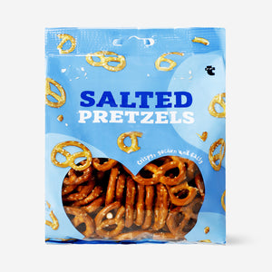 Golden Flying Tiger Copenhagen pretzels, crispy and twisted, served on a wooden platter with a rustic presentation.