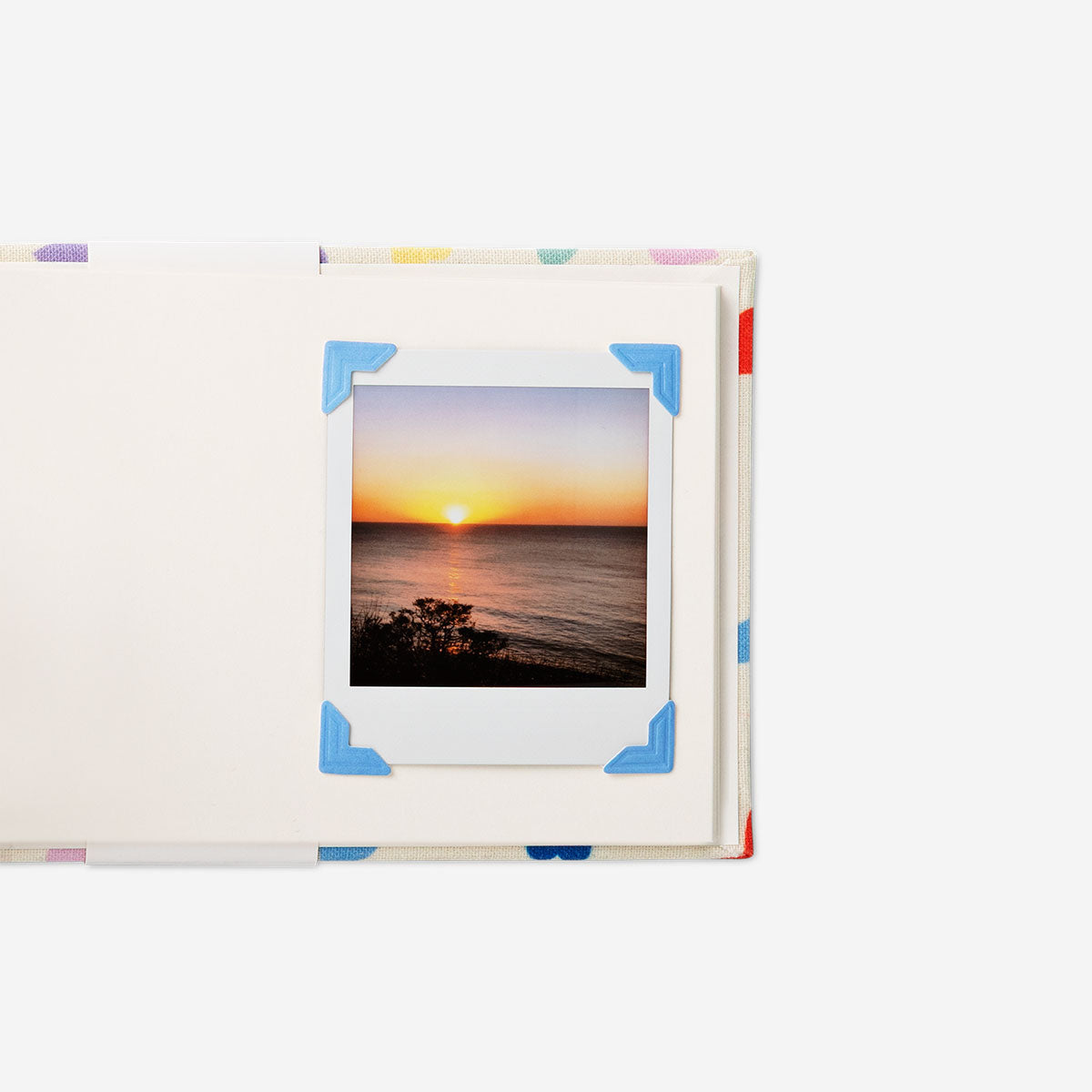 Set of 48 adhesive photo corners for albums, office use, by Flying Tiger Copenhagen, showing clear plastic corners for securing photos.