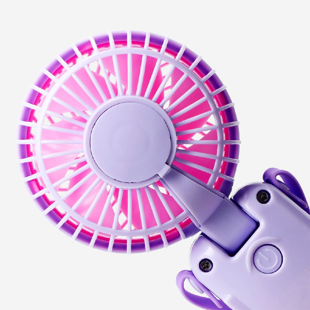 Flying Tiger Copenhagen handheld fan with strap in purple and pink, compact gadget for cooling on the go.