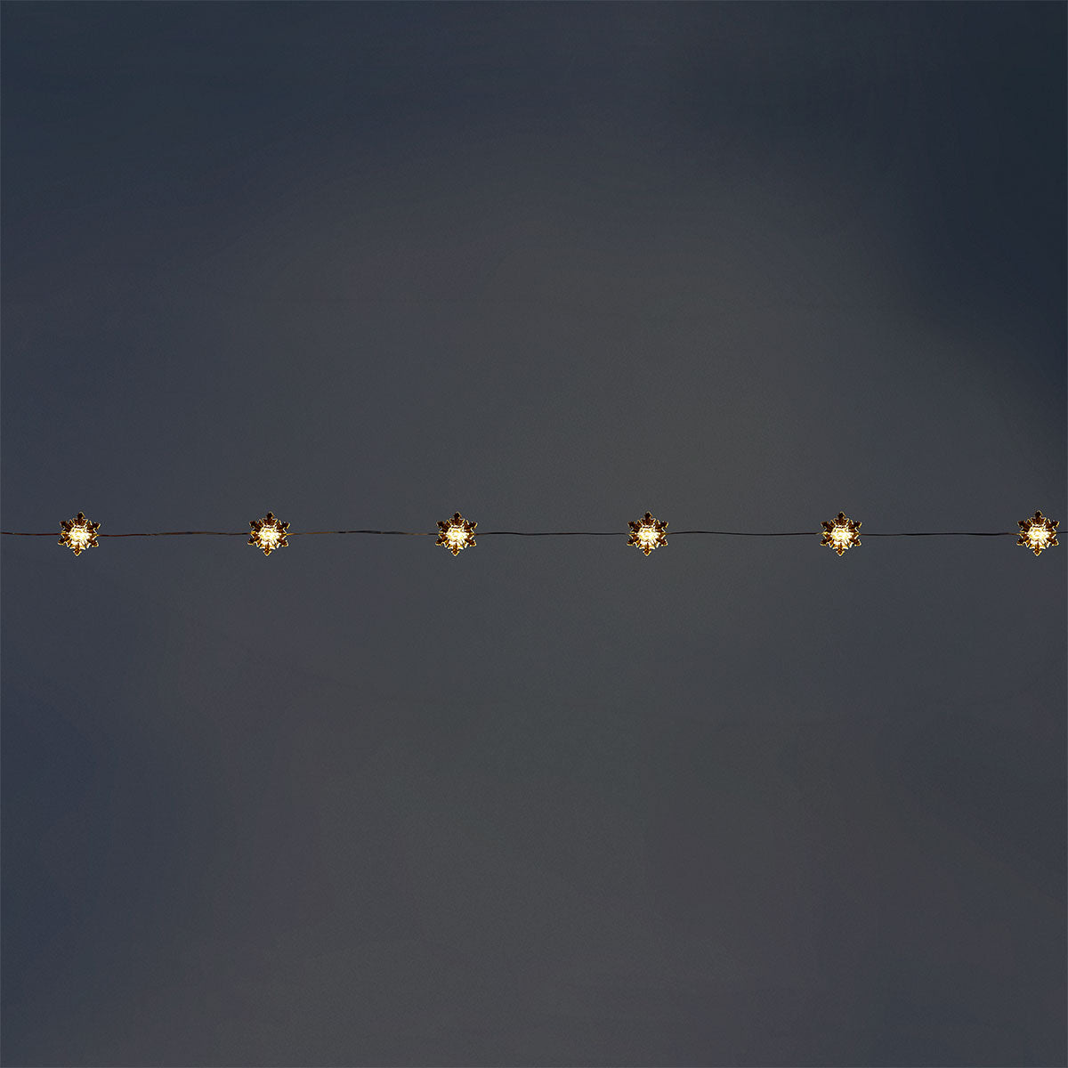 Flying Tiger Copenhagen snowflake string lights for home decor, featuring festive snowflake-shaped LED lights.