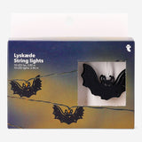 Black bat-shaped string lights for home decoration by Flying Tiger Copenhagen hanging against a wall.