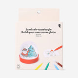 Colorful DIY snowglobe hobby kit with miniature scene and snow particles, by Flying Tiger Copenhagen.