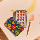 Mini watercolors in tin box for hobby painting by Flying Tiger Copenhagen, featuring vibrant watercolor pans in a compact metal case.