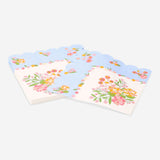 Set of 16 floral party napkins with scalloped edges by Flying Tiger Copenhagen, decorated with colorful flower patterns.