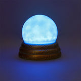 Flying Tiger Copenhagen scrying ball with light gadget showing a glowing glass sphere with swirling light effects.