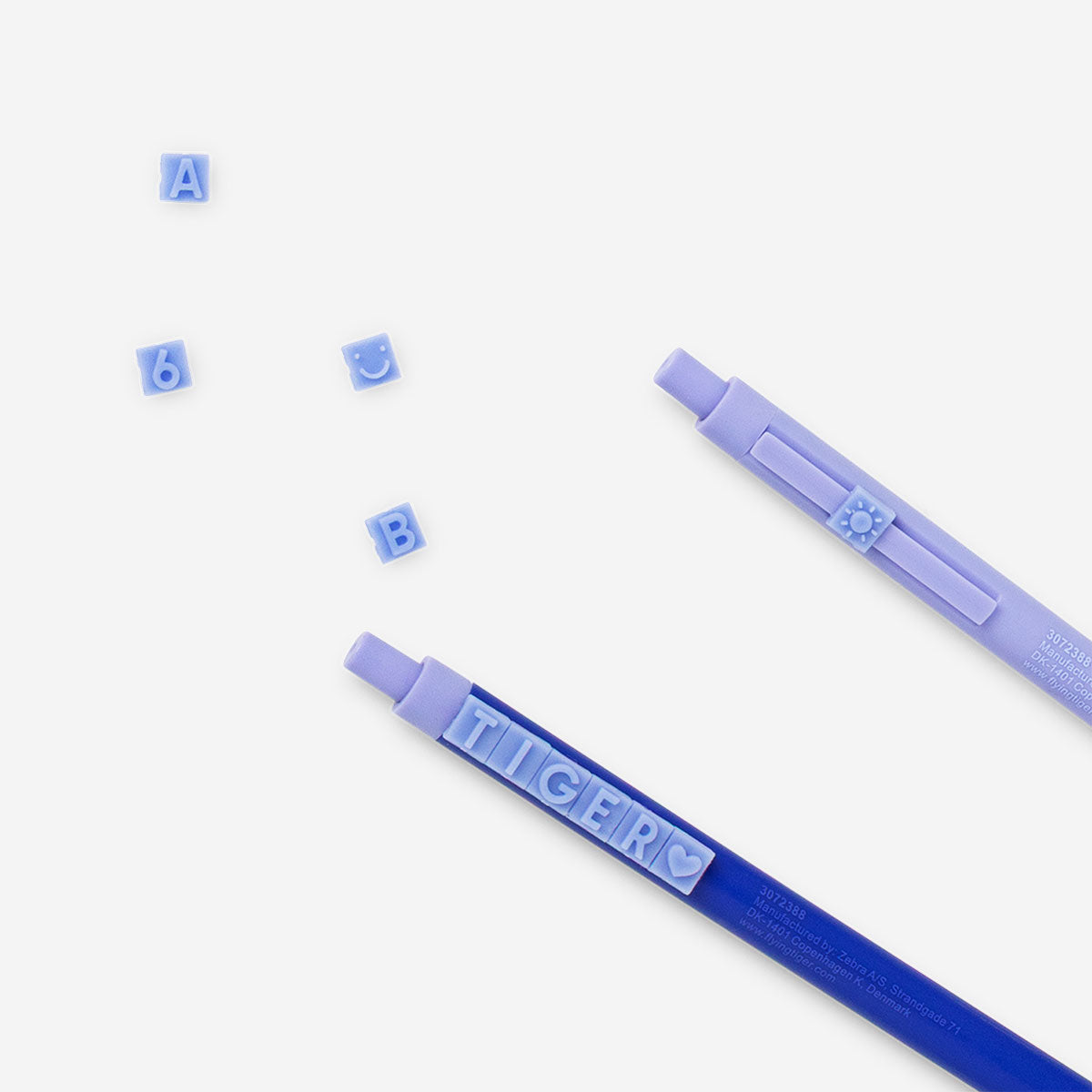 Two Flying Tiger Copenhagen ballpoint pens with letter designs for office use, featuring colorful ink and ergonomic grip.
