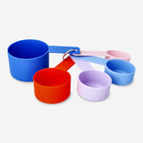 Set of four Flying Tiger Copenhagen designer collection measuring cups for kitchen use, with clear measurement markings.