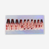 Flying Tiger Copenhagen press-on nails with a blood splatter design for a bold, edgy personal care accessory.