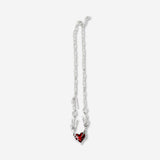 Silver textile necklace with a red heart pendant, stylish jewelry accessory from Flying Tiger Copenhagen.