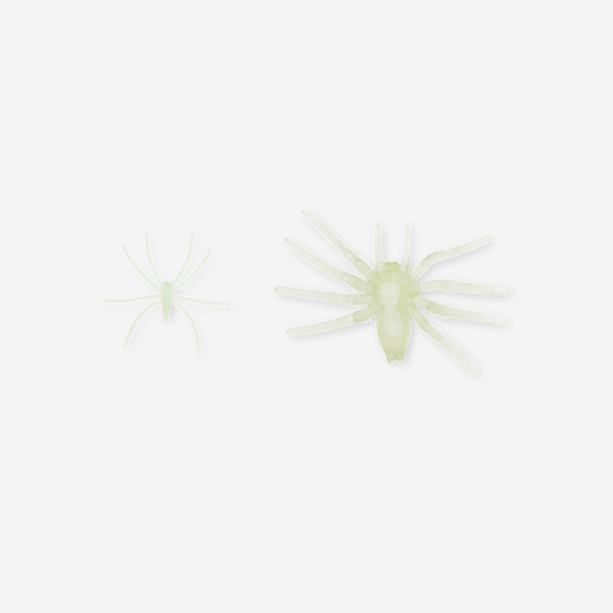 Set of 12 glow-in-the-dark spider decorations for parties by Flying Tiger Copenhagen, featuring spooky black spiders with glowing effects.