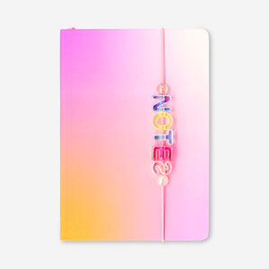A5 gradient office notebook with colorful charms and a heart-shaped mirror, by Flying Tiger Copenhagen.