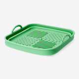 Square air fryer liner from Flying Tiger Copenhagen, 19x19 cm, designed for easy cleaning and oven-safe use in kitchen appliances.