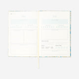 Flying Tiger Copenhagen floral wellness journal with a colorful floral cover, designed for office use and personal well-being.