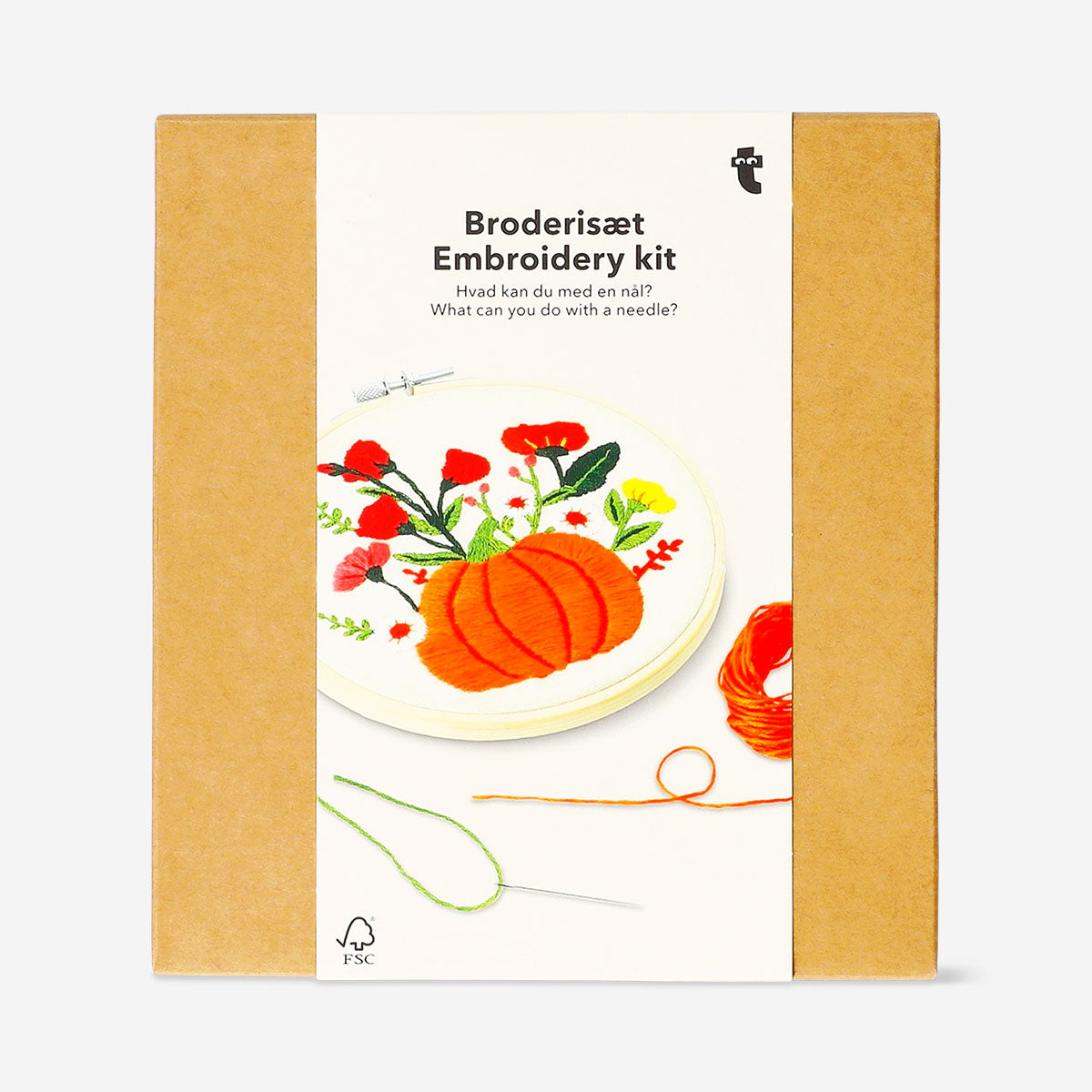 Embroidery kit with autumnal print by Flying Tiger Copenhagen, showing colorful threads, fabric, and embroidery tools.