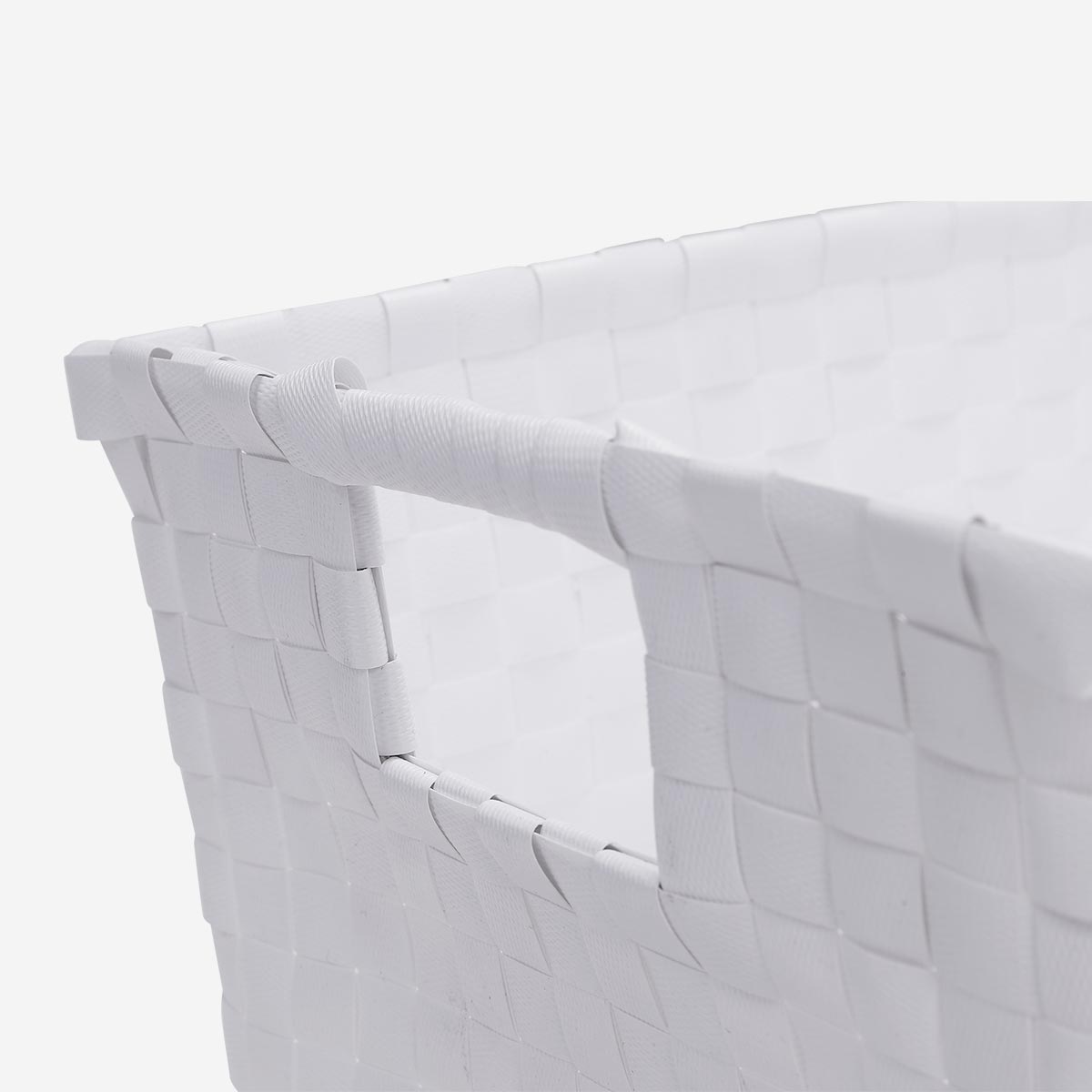 White braided plastic storage basket for home organization, made by Flying Tiger Copenhagen.