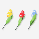 Three honeycomb paper flower decorations in pastel colors for party decor, by Flying Tiger Copenhagen.