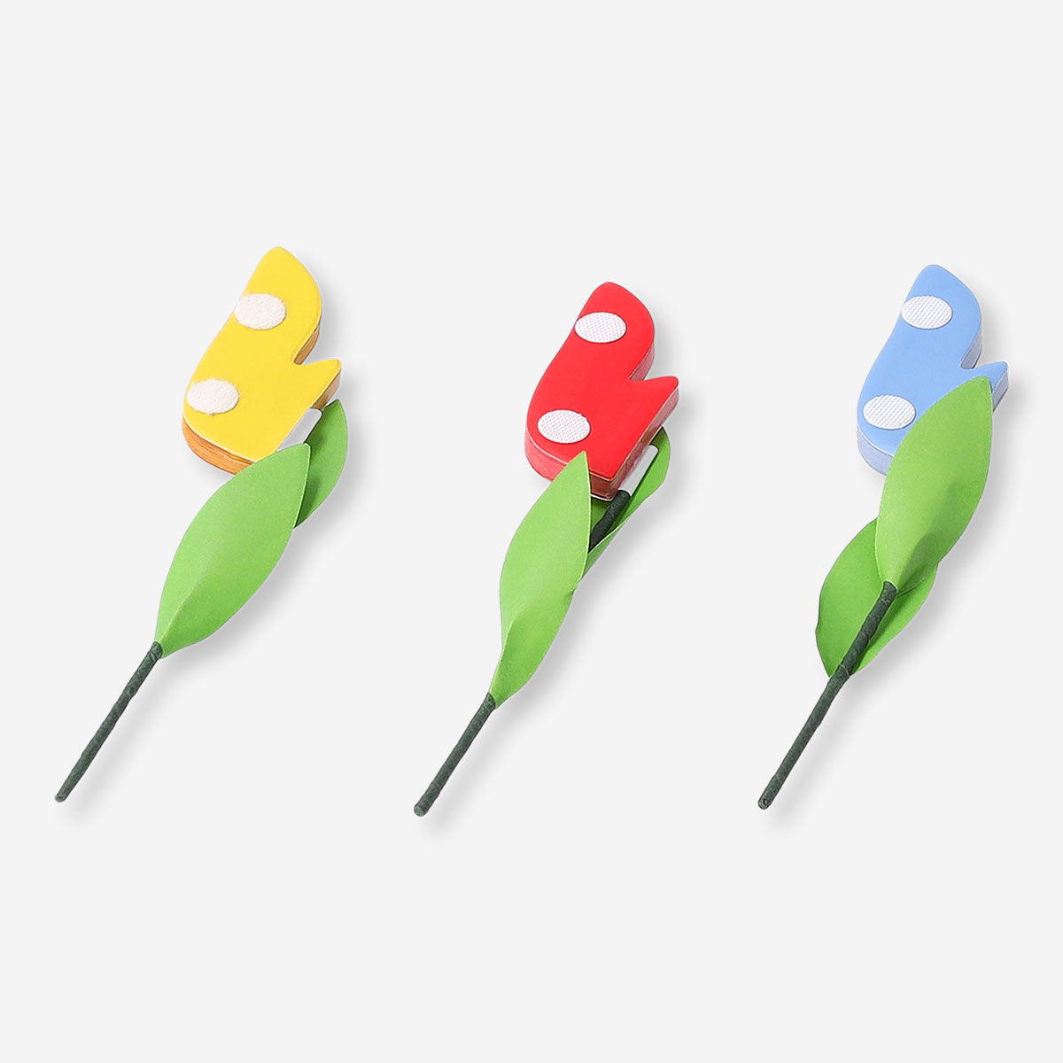 Three honeycomb paper flower decorations in pastel colors for party decor, by Flying Tiger Copenhagen.