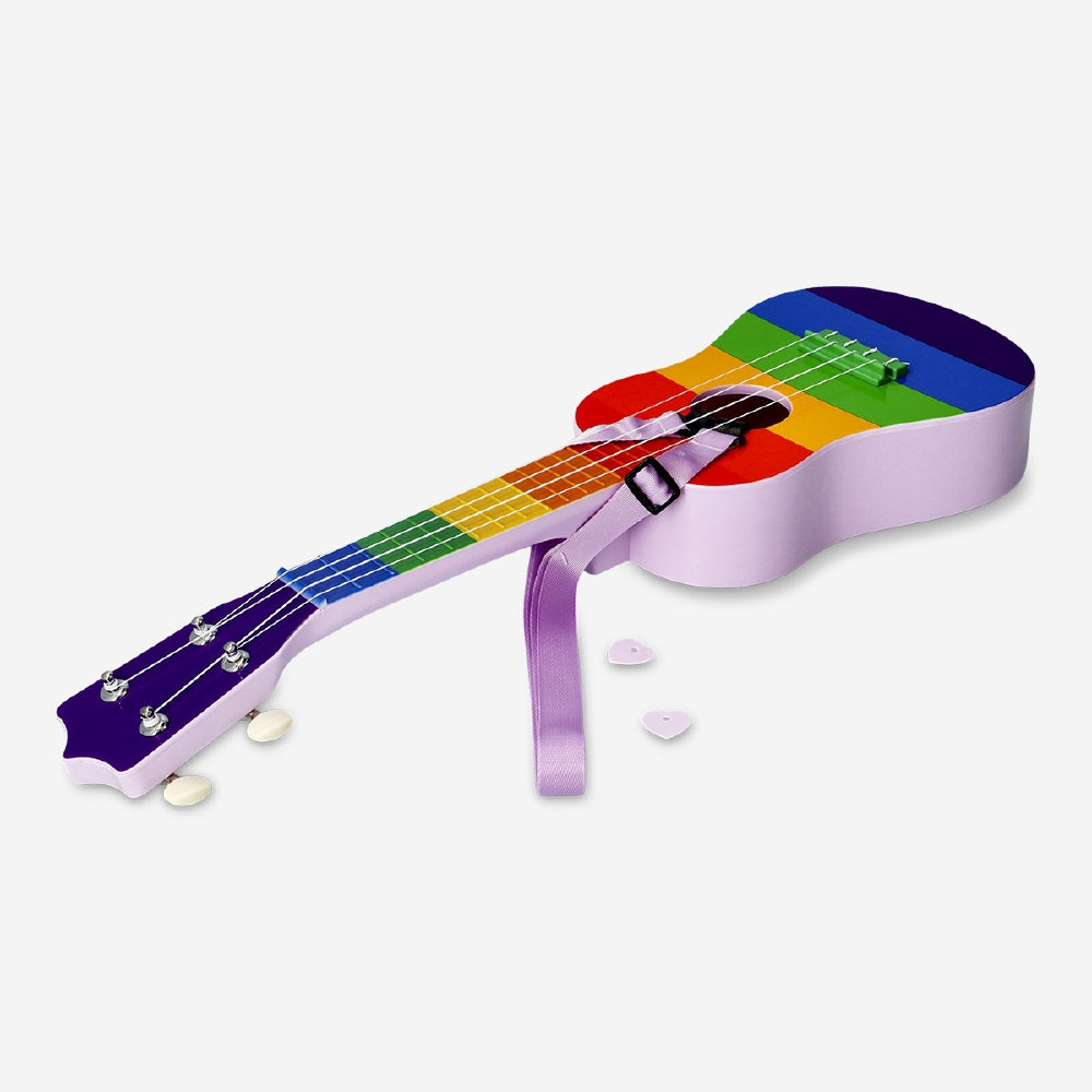 Rainbow ukulele with strap, colorful string instrument gadget by Flying Tiger Copenhagen, displayed with vibrant hues.