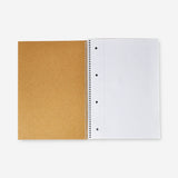 A4 spiral-bound grid notebook with a craft paper cover from Flying Tiger Copenhagen, open to blank grid pages.