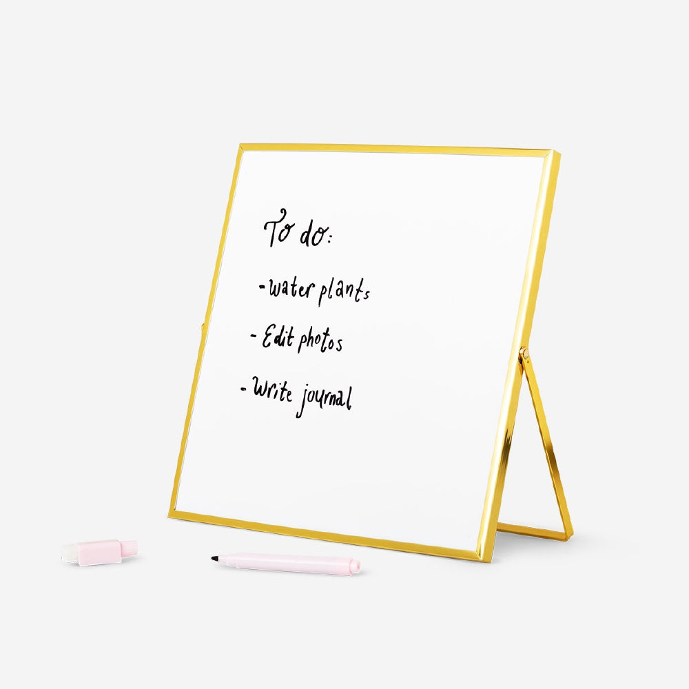 Gold magnetic office board with marker from Flying Tiger Copenhagen, featuring a sleek surface and a magnetic writing area.