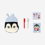 Office stationery kit featuring a plush penguin from Flying Tiger Copenhagen, including pens, notepads, and small desk accessories.