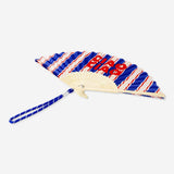 Foldable bamboo fan with Ciao Ciao print and strap, lightweight textile fan by Flying Tiger Copenhagen, perfect for warm weather.