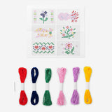 Embroidery kit in a wooden box by Flying Tiger Copenhagen, featuring colorful threads and embroidery accessories inside.