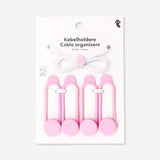 Pink media cable organizers, set of 4, from Flying Tiger Copenhagen, neatly arranged to manage and store electronic cords.