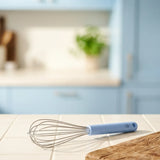 Flying Tiger Copenhagen Designer Collection whisk, 29 cm kitchen tool with a stainless steel handle and wire loops for mixing.