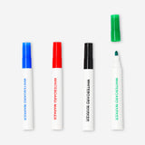 Set of four Flying Tiger Copenhagen whiteboard markers with colorful caps for office and classroom use.