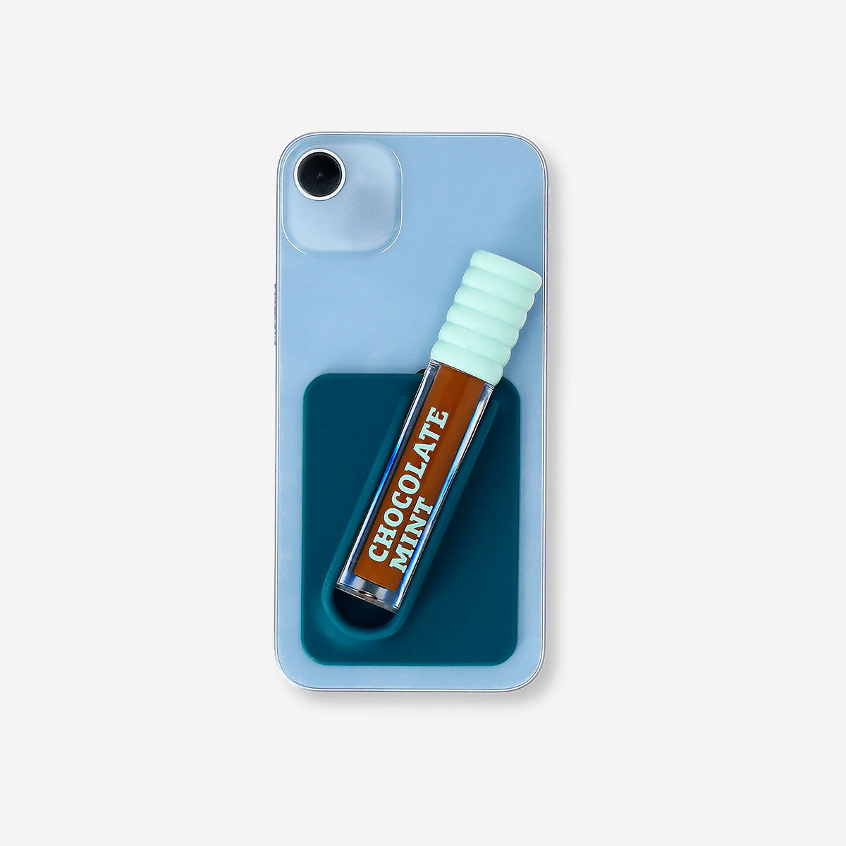 Blue lip gloss holder for phone cover, branded Flying Tiger Copenhagen, featuring a decorative lip gloss design.