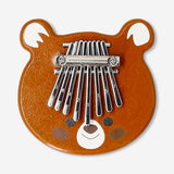 Wooden toy kalimba by Flying Tiger Copenhagen showing its small wooden body and metal tines for musical play.