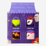 Flying Tiger Copenhagen press me Halloween character gadgets inside haunted house display, featuring spooky themed toys for Halloween fun.