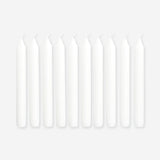 Set of three white dinner candles from Flying Tiger Copenhagen, 10-piece home candle set on a clean surface.