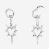 Silver heart-shaped hanging earrings with spiky textile design from Flying Tiger Copenhagen, featuring a modern and edgy jewelry style.