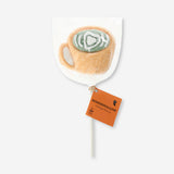 Marshmallow on a stick with matcha latte flavor, featuring green matcha coating and a wooden stick, from Flying Tiger Copenhagen.