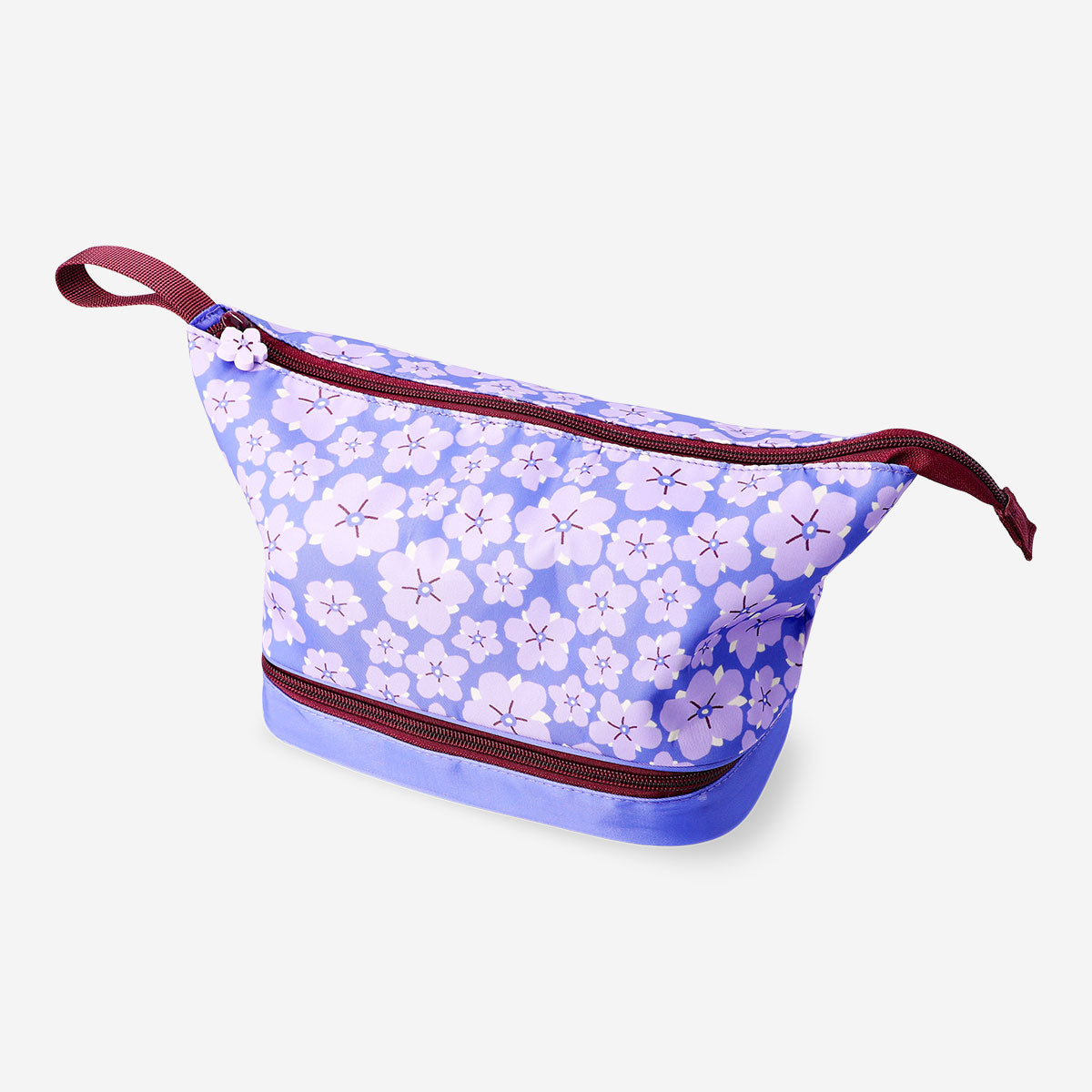 Purple floral Flying Tiger Copenhagen leisure toiletry bag with two compartments, featuring a vibrant floral pattern and zipper closures.