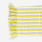 Yellow striped throw blanket with fringes, 120x170 cm, from Flying Tiger Copenhagen, shown draped on a cozy living room sofa.